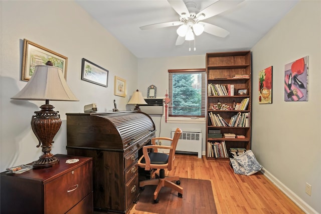 6404 78th St, Middle Village, NY 11379 - office area featuring radiator heating unit, ceiling fan, and light wood-style floors