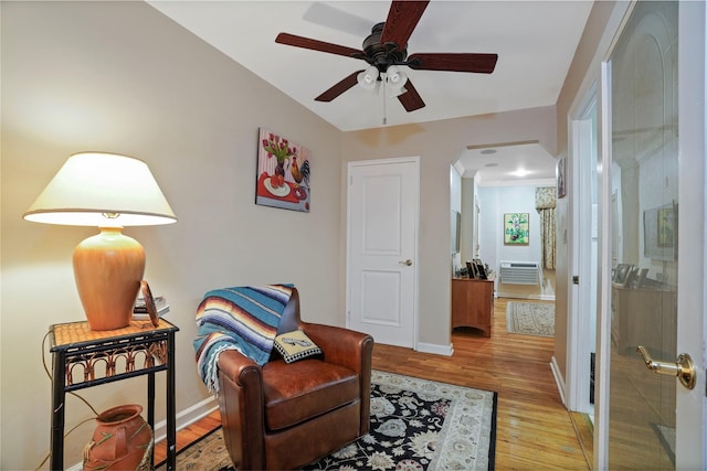 6404 78th St, Middle Village, NY 11379 - living area with wood finished floors, arched walkways, and a ceiling fan