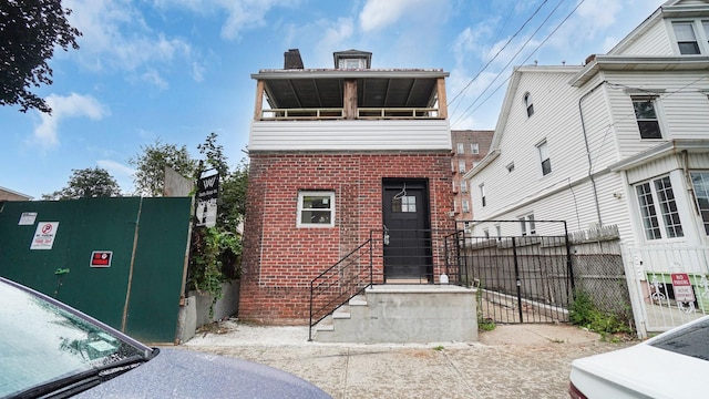 679 E 221st St, Bronx, NY 10467 - view of front facade featuring brick siding and a chimney