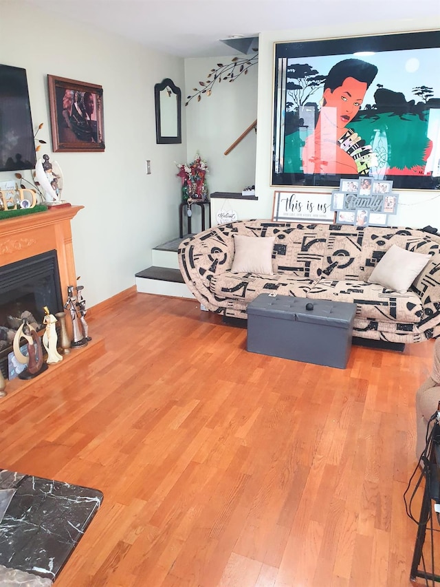 12826 Gotham Rd, South Ozone Park, NY 11420 - living room with wood finished floors and a glass covered fireplace