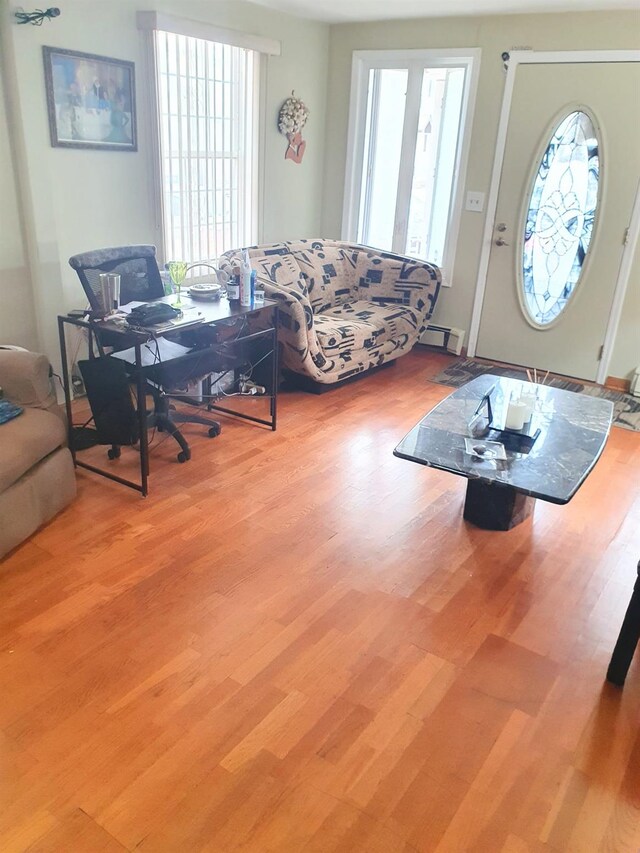 12826 Gotham Rd, South Ozone Park, NY 11420 - living area with wood finished floors and a desk