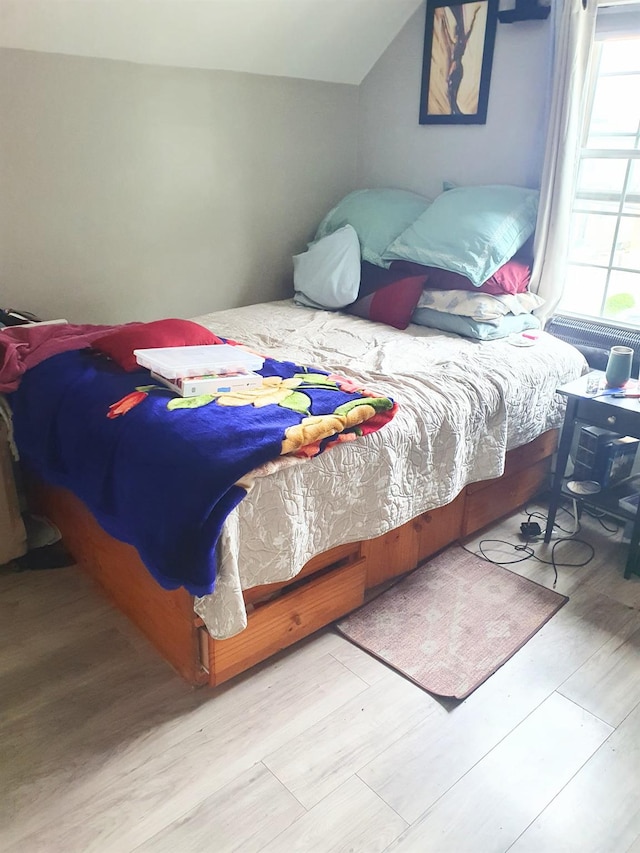 12826 Gotham Rd, South Ozone Park, NY 11420 - bedroom with wood finished floors and vaulted ceiling