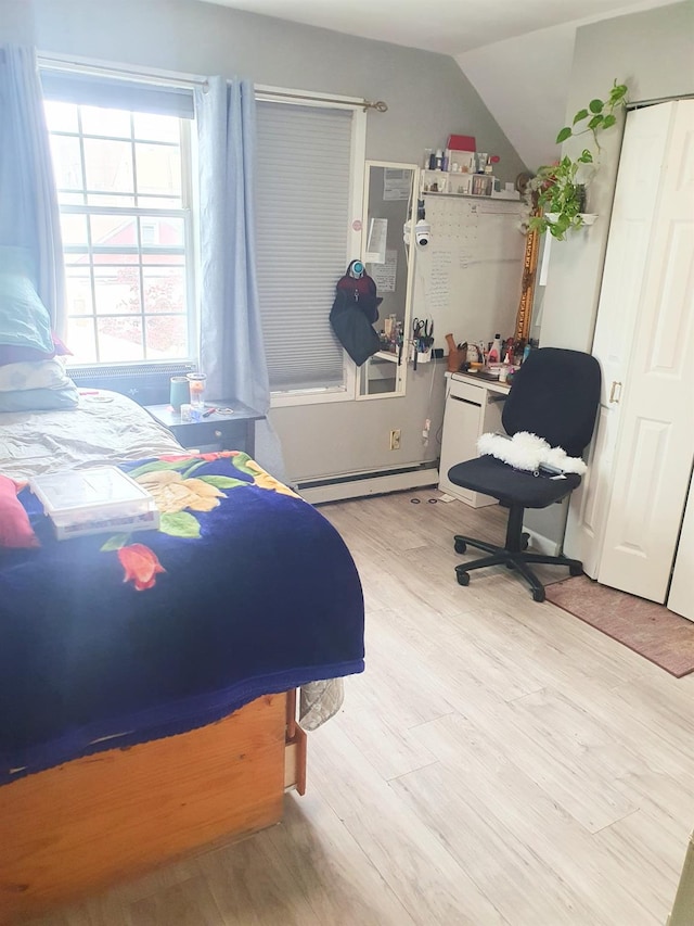 12826 Gotham Rd, South Ozone Park, NY 11420 - bedroom featuring wood finished floors, baseboard heating, and lofted ceiling