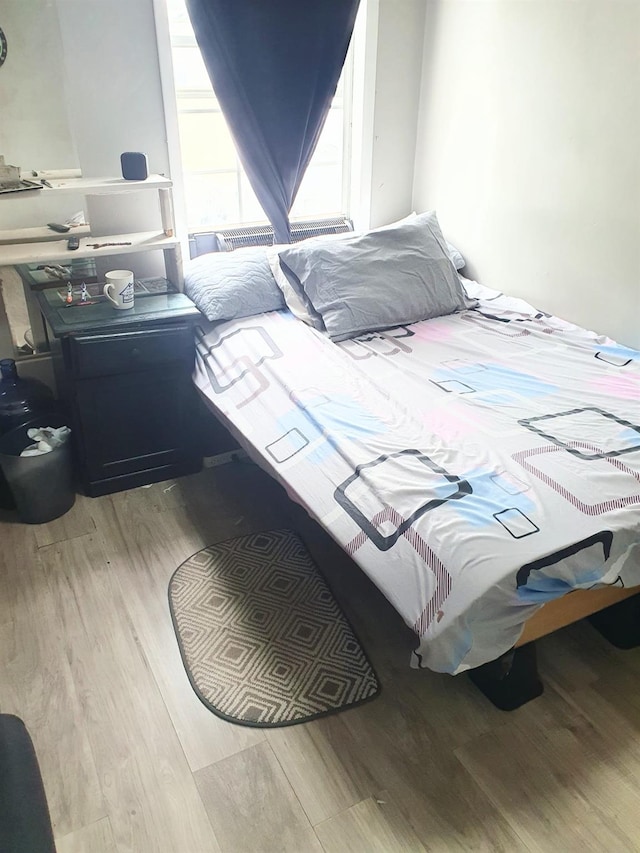 12826 Gotham Rd, South Ozone Park, NY 11420 - bedroom featuring wood finished floors