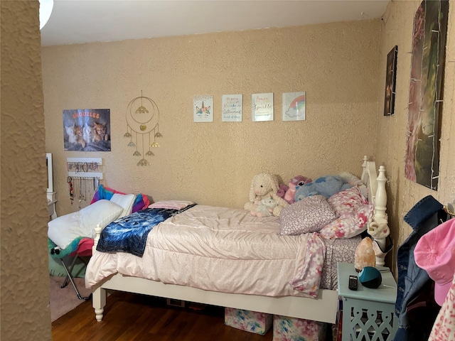 179 Clinton Ave, East Patchogue, NY 11772 - bedroom featuring wood finished floors and a textured wall