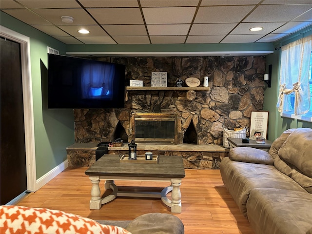 179 Clinton Ave, East Patchogue, NY 11772 - living area featuring a paneled ceiling, wood finished floors, and a stone fireplace