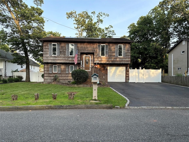 179 Clinton Ave, East Patchogue, NY 11772 - bi-level home featuring asphalt driveway and an attached garage