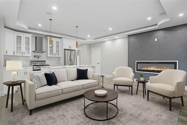46 S 12th Ave, Mount Vernon, NY 10550 - living room featuring a raised ceiling, recessed lighting, light wood-style flooring, and a fireplace