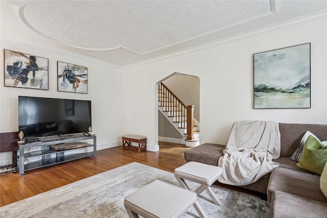 222 E 4th St, Mount Vernon, NY 10553 - living room with hardwood / wood-style flooring, ornamental molding, stairs, a textured ceiling, and arched walkways