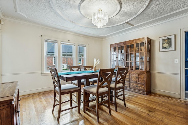 222 E 4th St, Mount Vernon, NY 10553 - dining room featuring light wood-style flooring, a chandelier, a textured ceiling, and ornamental molding
