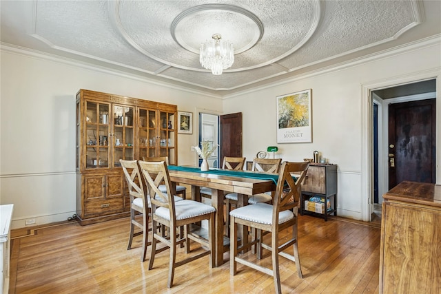 222 E 4th St, Mount Vernon, NY 10553 - dining space featuring a textured ceiling, light wood-style flooring, a chandelier, and crown molding