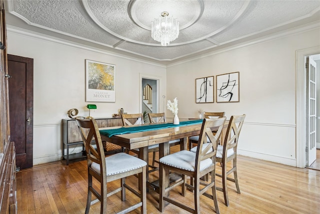 222 E 4th St, Mount Vernon, NY 10553 - dining space featuring a chandelier, light wood-type flooring, a textured ceiling, and crown molding