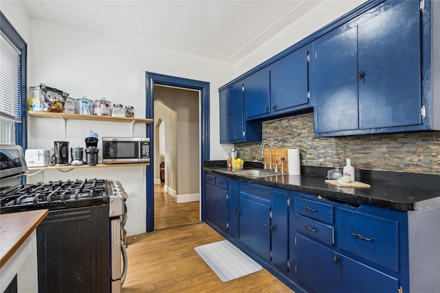 222 E 4th St, Mount Vernon, NY 10553 - kitchen with appliances with stainless steel finishes, blue cabinets, decorative backsplash, and light wood-style flooring