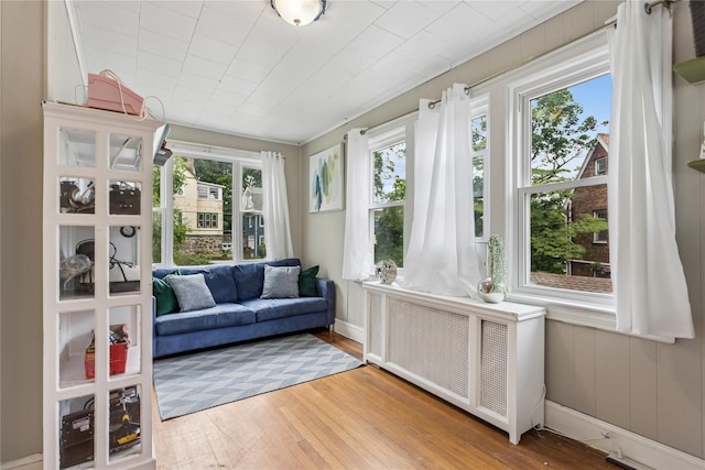 222 E 4th St, Mount Vernon, NY 10553 - sunroom featuring radiator heating unit, healthy amount of natural light, and wood finished floors