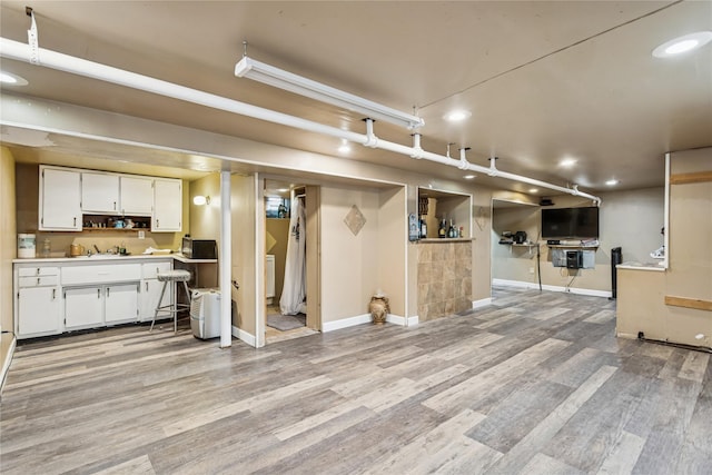 222 E 4th St, Mount Vernon, NY 10553 - kitchen with light wood-style floors, white cabinets, light countertops, recessed lighting, and black microwave