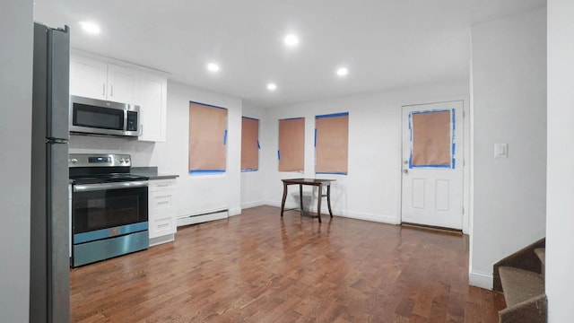 1823 Anthony Ave, Bronx, NY 10457 - kitchen with stainless steel appliances, baseboard heating, white cabinetry, recessed lighting, and dark wood-style floors