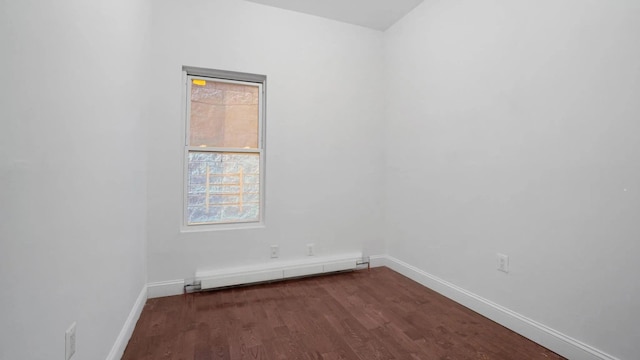 1823 Anthony Ave, Bronx, NY 10457 - spare room featuring a baseboard heating unit and dark wood-style flooring