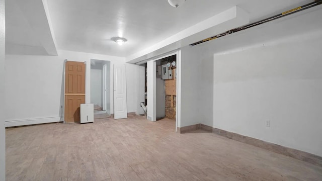 1823 Anthony Ave, Bronx, NY 10457 - unfurnished bedroom featuring a baseboard heating unit and light wood-style floors