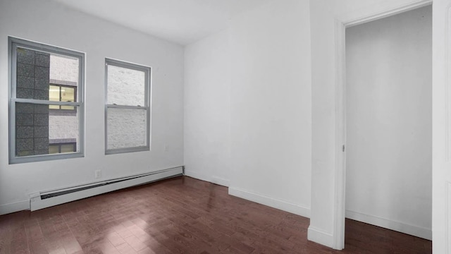 1823 Anthony Ave, Bronx, NY 10457 - unfurnished bedroom featuring a baseboard heating unit and wood finished floors