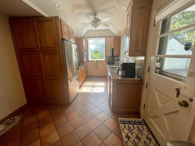 390 Atlantic Ave, East Rockaway, NY 11518 - kitchen with freestanding refrigerator, ceiling fan, lofted ceiling, light countertops, and light tile patterned floors