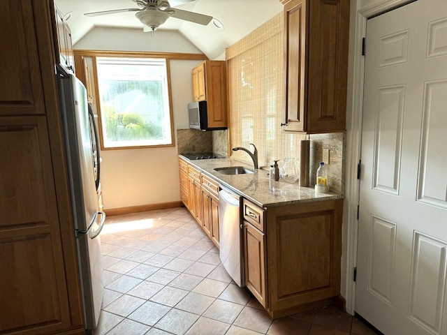390 Atlantic Ave, East Rockaway, NY 11518 - kitchen with appliances with stainless steel finishes, ceiling fan, vaulted ceiling, light tile patterned flooring, and light stone countertops