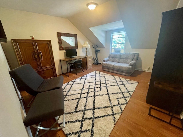 390 Atlantic Ave, East Rockaway, NY 11518 - living area featuring vaulted ceiling and wood finished floors
