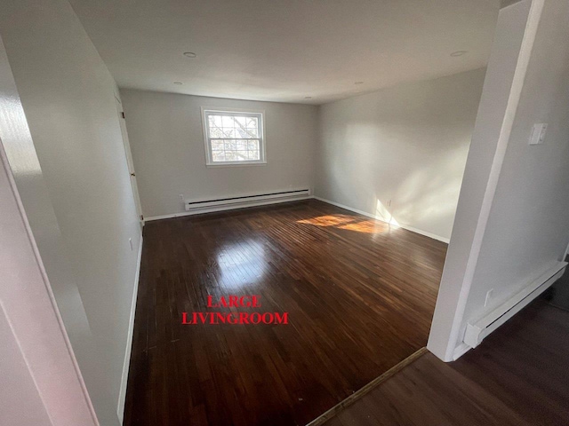 390 Atlantic Ave, East Rockaway, NY 11518 - empty room with a baseboard radiator and wood finished floors