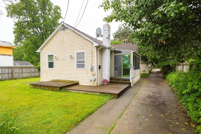 10 Tobacco Ln, Red Hook, NY 12571 - rear view of house with a wooden deck, a chimney, and a sunroom