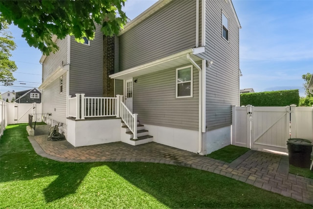 393 S 4th St, Lindenhurst, NY 11757 - back of property featuring a gate, a fenced backyard, and a patio area