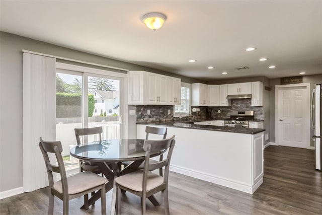 393 S 4th St, Lindenhurst, NY 11757 - dining space with dark wood-type flooring and recessed lighting