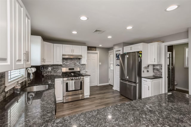 393 S 4th St, Lindenhurst, NY 11757 - kitchen featuring stainless steel appliances, under cabinet range hood, white cabinets, tasteful backsplash, and recessed lighting