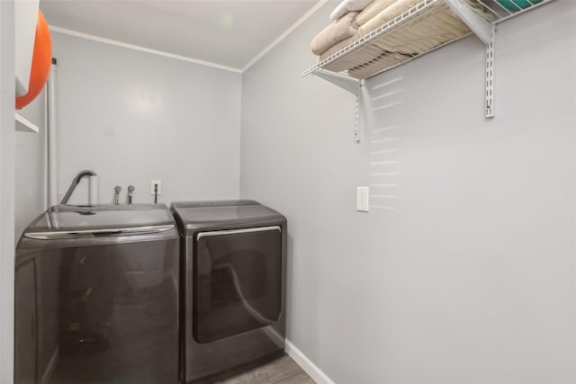 393 S 4th St, Lindenhurst, NY 11757 - washroom with washing machine and dryer, crown molding, and wood finished floors