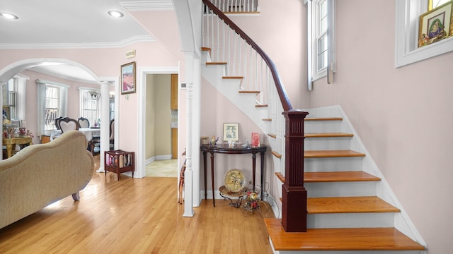 89-10 189th St, Hollis, NY 11423 - staircase featuring arched walkways, wood finished floors, crown molding, ornate columns, and recessed lighting