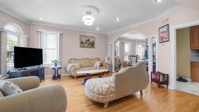 89-10 189th St, Hollis, NY 11423 - living area with decorative columns, arched walkways, light wood-style flooring, ornamental molding, and recessed lighting