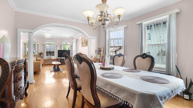 89-10 189th St, Hollis, NY 11423 - dining area with ornate columns, a chandelier, arched walkways, light wood-style floors, and ornamental molding