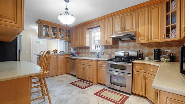 89-10 189th St, Hollis, NY 11423 - kitchen featuring stainless steel appliances, under cabinet range hood, light countertops, and backsplash