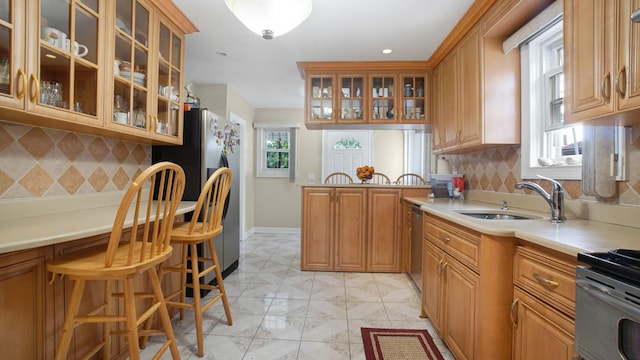 89-10 189th St, Hollis, NY 11423 - kitchen with light countertops, decorative backsplash, and glass insert cabinets