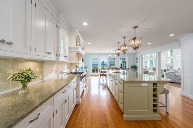 4510 Peconic Bay Blvd, Laurel, NY 11948 - kitchen with white cabinets, light wood finished floors, recessed lighting, and light stone counters
