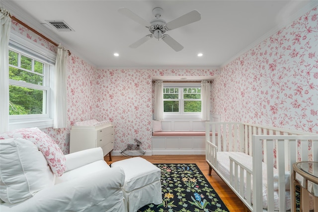 4510 Peconic Bay Blvd, Laurel, NY 11948 - bedroom with multiple windows, crown molding, wood finished floors, wallpapered walls, and recessed lighting