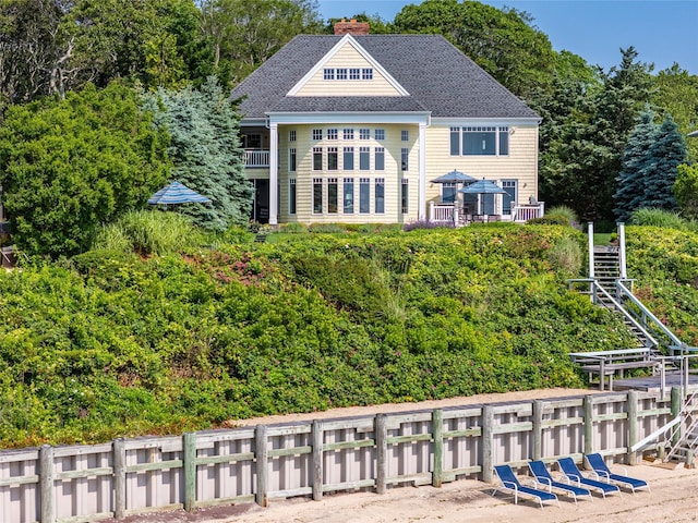 4510 Peconic Bay Blvd, Laurel, NY 11948 - back of house with a chimney, roof with shingles, and stairs