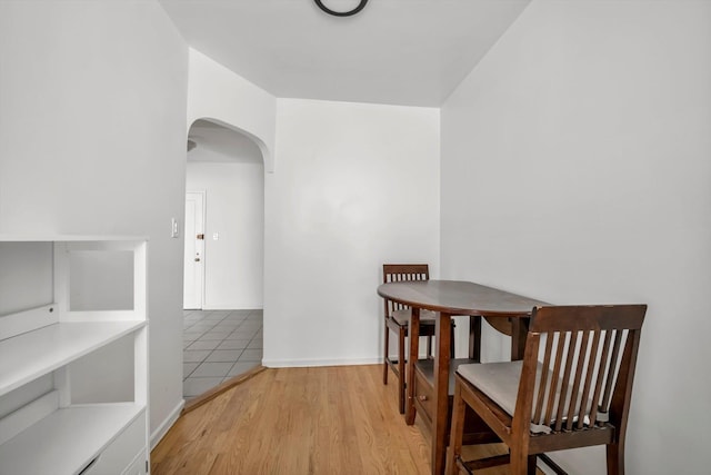 63-60 102nd St Unit A8, Rego Park, NY 11374 - dining space featuring arched walkways and light wood-type flooring
