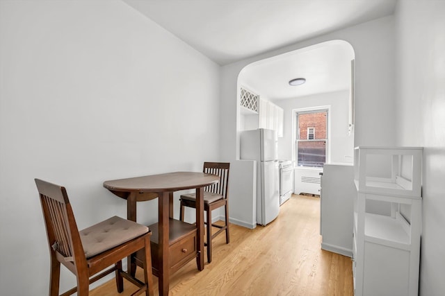 63-60 102nd St Unit A8, Rego Park, NY 11374 - dining area featuring light wood-type flooring and arched walkways