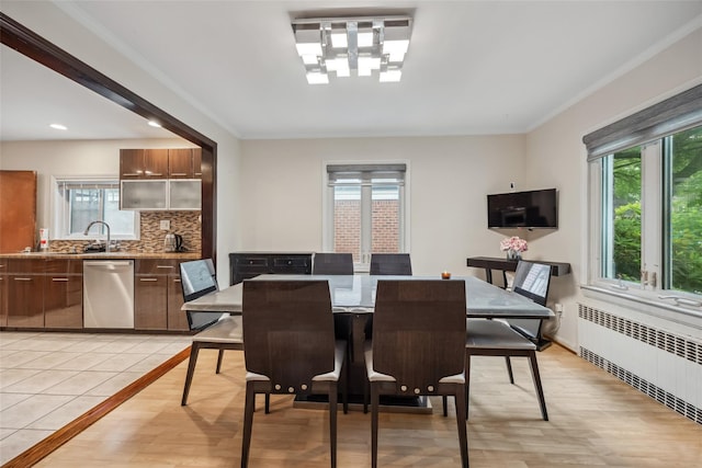 213-09 64th Ave, Oakland Gardens, NY 11364 - dining area featuring radiator, healthy amount of natural light, ornamental molding, and light wood finished floors