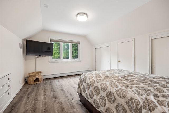 213-09 64th Ave, Oakland Gardens, NY 11364 - bedroom with a baseboard radiator, wood finished floors, vaulted ceiling, and two closets