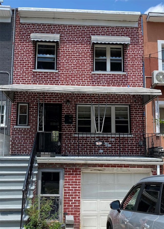 1319 Hicks St, Bronx, NY 10469 - view of front of property with brick siding and an attached garage