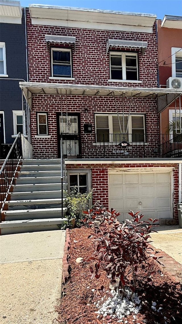 1319 Hicks St, Bronx, NY 10469 - view of property with brick siding, a garage, and driveway