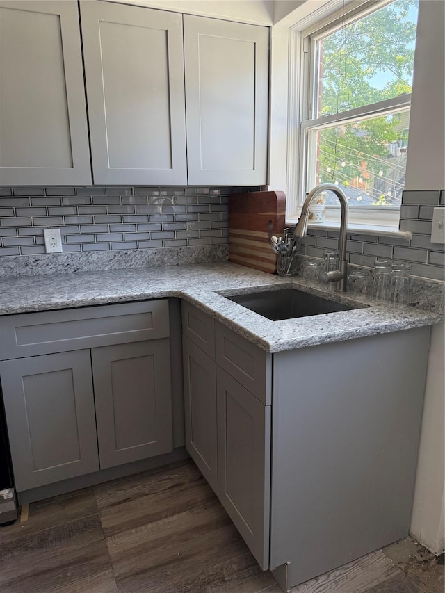 1319 Hicks St, Bronx, NY 10469 - kitchen featuring gray cabinets, backsplash, and light stone counters
