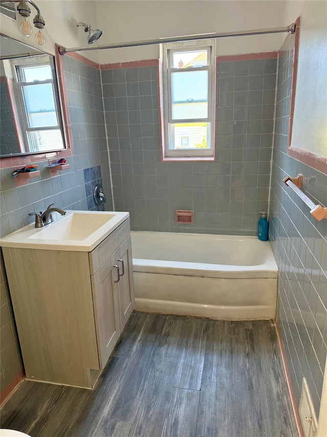 1319 Hicks St, Bronx, NY 10469 - full bath with tile walls, wood finished floors, vanity, and shower / washtub combination