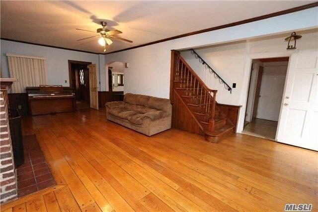 85-24 Eton St, Jamaica Estates, NY 11432 - living room featuring stairs, light wood-type flooring, a ceiling fan, crown molding, and arched walkways