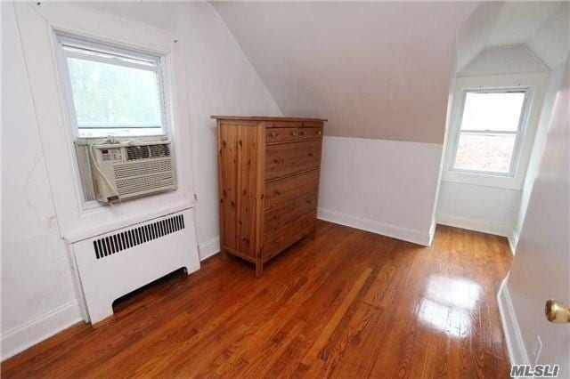 85-24 Eton St, Jamaica Estates, NY 11432 - bonus room with radiator heating unit, lofted ceiling, wood finished floors, and cooling unit